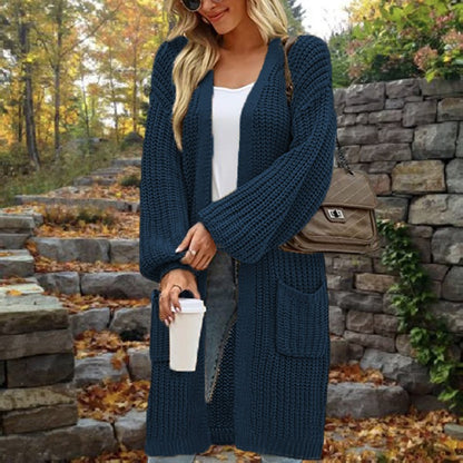 woman-in-a-long-navy-swaeter-and-a-white-cup-in-herhands